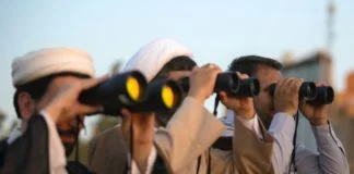 three men using binoculars